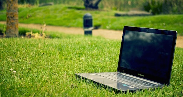Laptop laid on grass